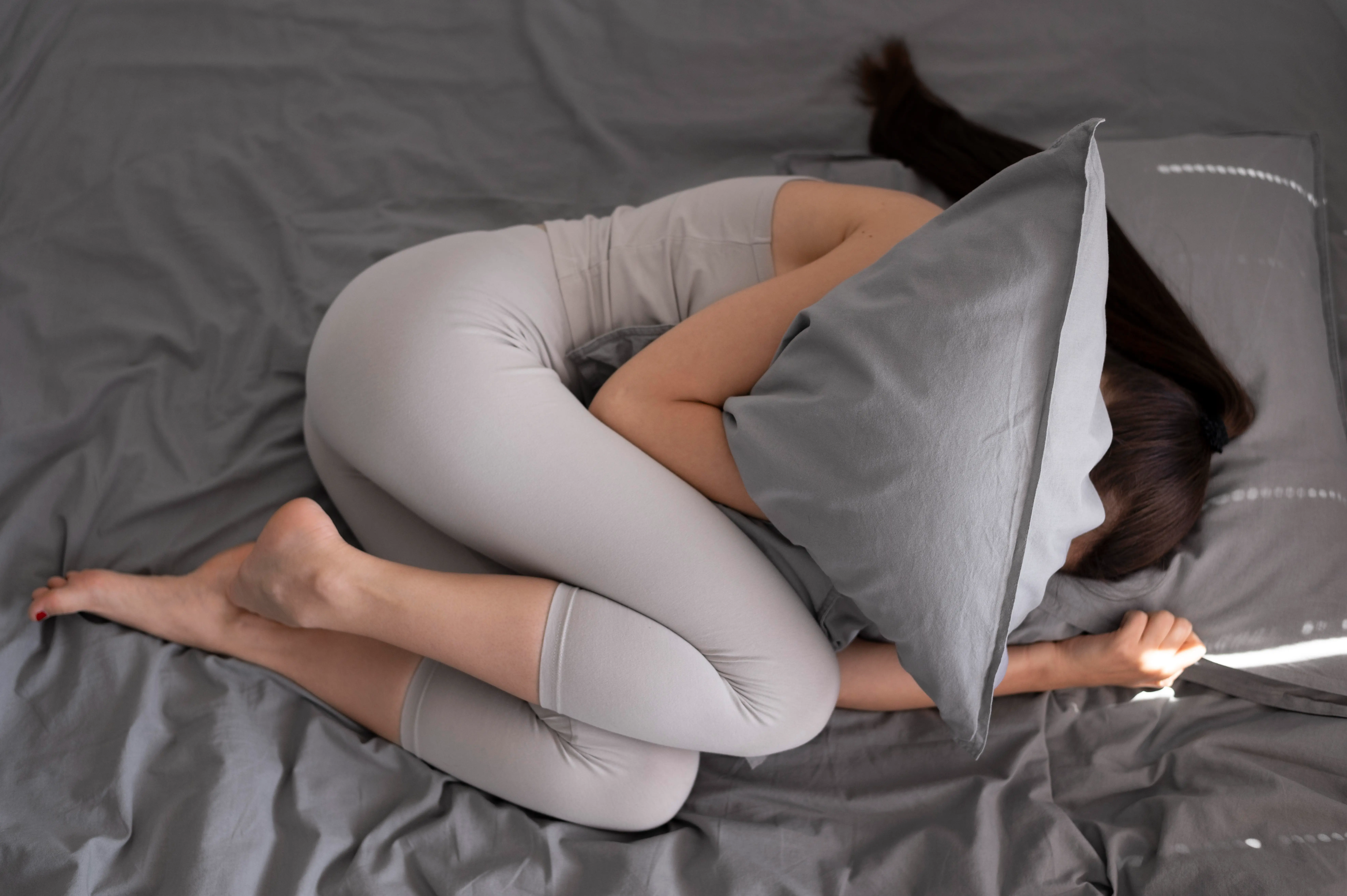 full shot woman holding pillow